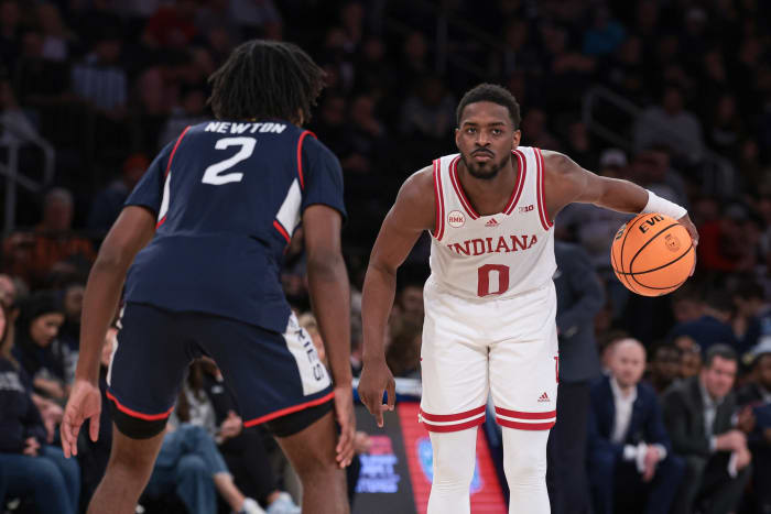 Indiana Hoosiers guard Xavier Johnson (0) dribbles in front of Connecticut Huskies guard Tristen Newton (2) during the second half at Madison Square Garden.